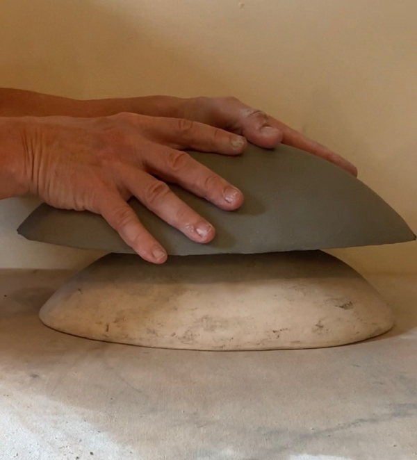 Susan Bergman demonstratiing how to use a bisque mold.